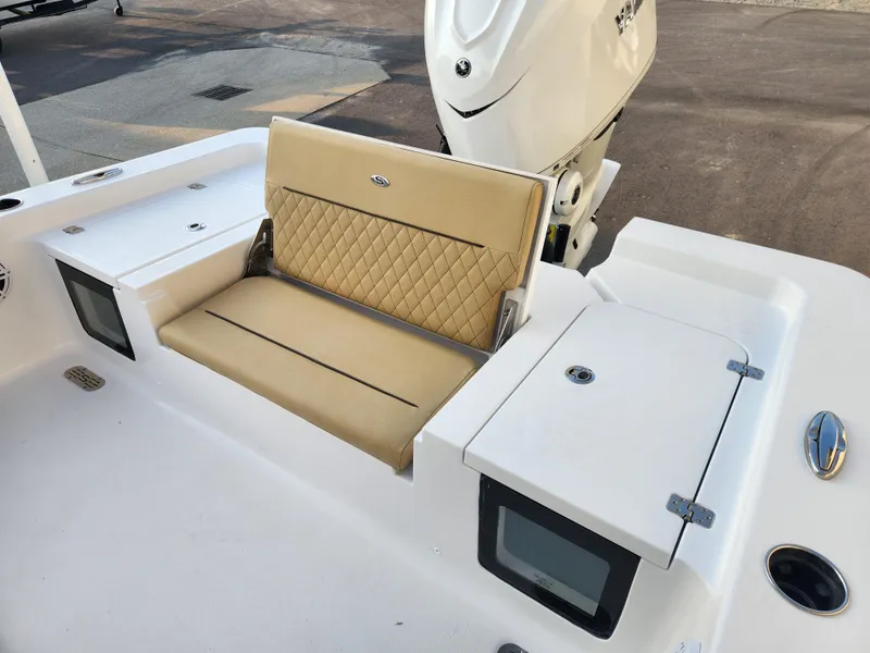 Slide: The Image of 2025 Sportsman Masters 247OE Bay Boat with tan seating and storage compartments. - 20