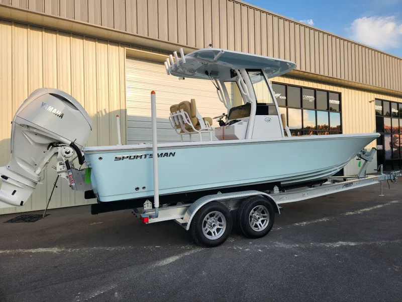Slide: The Image of 2025 Sportsman Masters 247OE Bay Boat on trailer, parked outside a building. - 3
