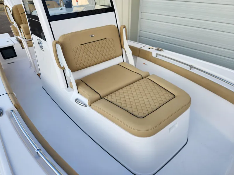 Slide: The Image of 2025 Sportsman Masters 247OE Bay Boat with tan cushioned seating and sleek design. - 7
