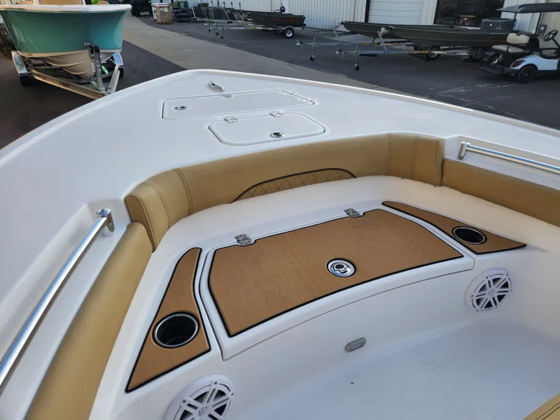 Slide: The Image of 2025 Sportsman Masters 247OE Bay Boat interior with cushioned seating and cup holders. - 9