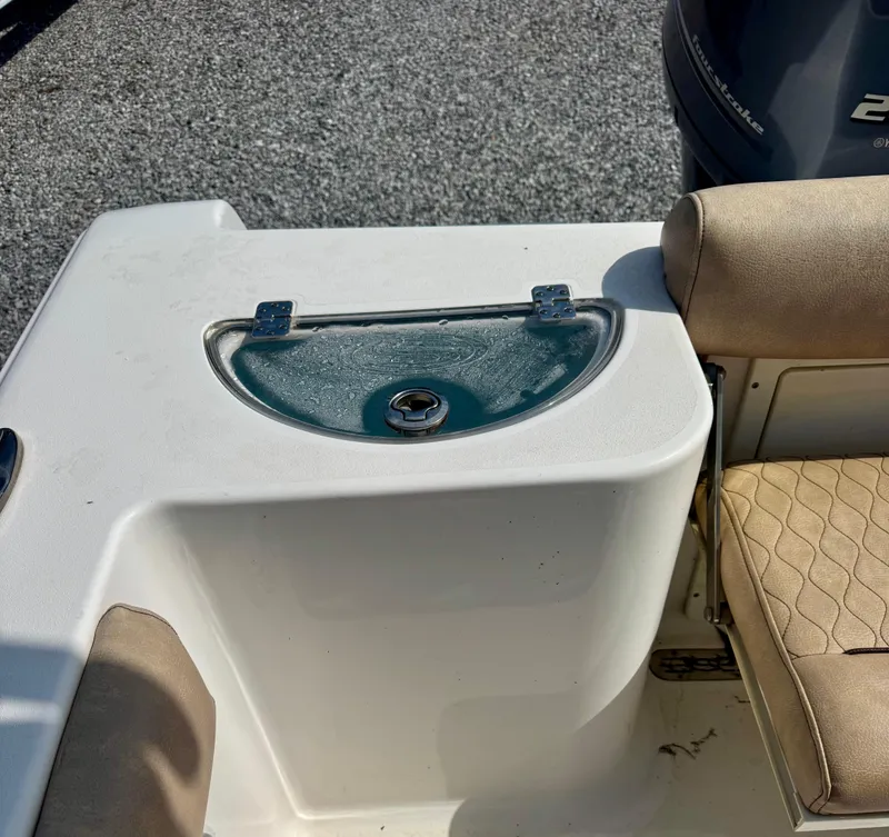Slide: The Image of 2020 Sportsman Open 212 Center Console boat interior with seating and storage compartment. - 10