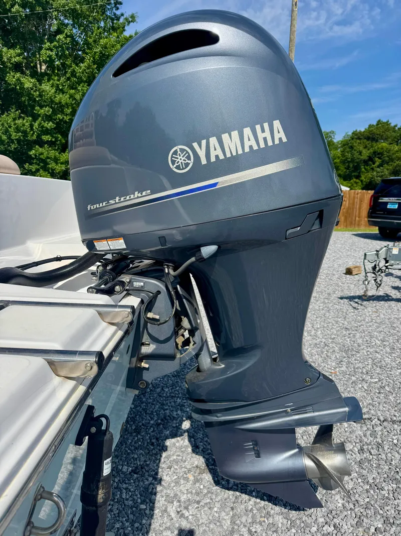 Slide: The Image of 2020 Sportsman Open 212 Center Console with Yamaha outboard motor, parked on gravel. - 4