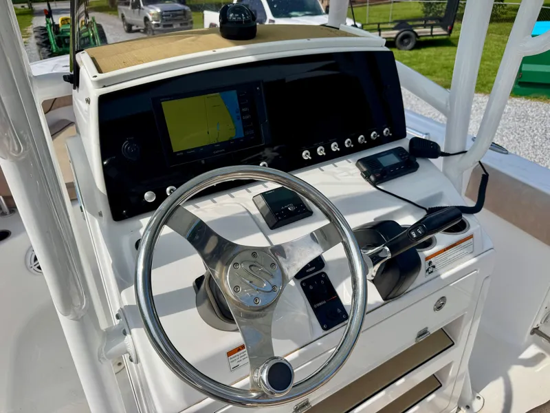 Slide: The Image of 2020 Sportsman Open 212 Center Console boat dashboard with steering wheel and navigation controls. - 6