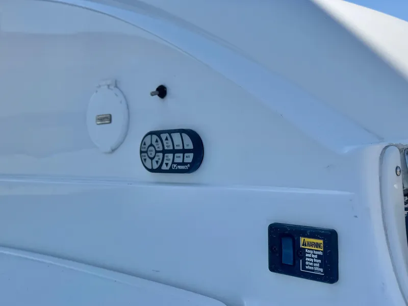 Slide: The Image of Control panel on a 2006 Cobalt 232 boat, featuring various switches and a warning label. - 10