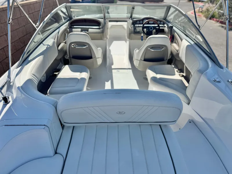 Slide: The Image of Interior of a 2006 Cobalt 232 boat with white seating and steering wheel. - 11