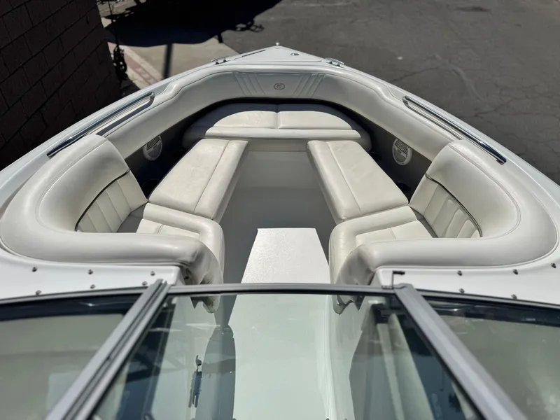 Slide: The Image of 2006 Cobalt 232 boat with white cushioned seating in the bow area. - 13