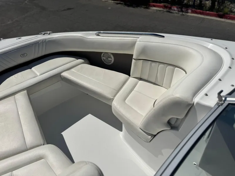 Slide: The Image of 2006 Cobalt 232 boat interior with white leather seating and speaker. - 15