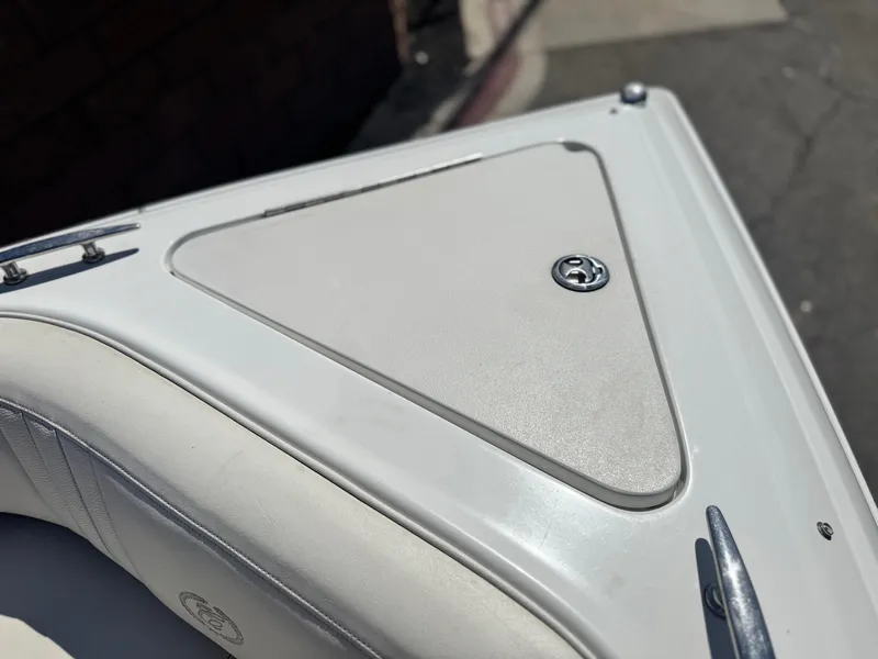 Slide: The Image of 2006 Cobalt 232 boat detail, featuring a sleek white deck with a storage compartment. - 16