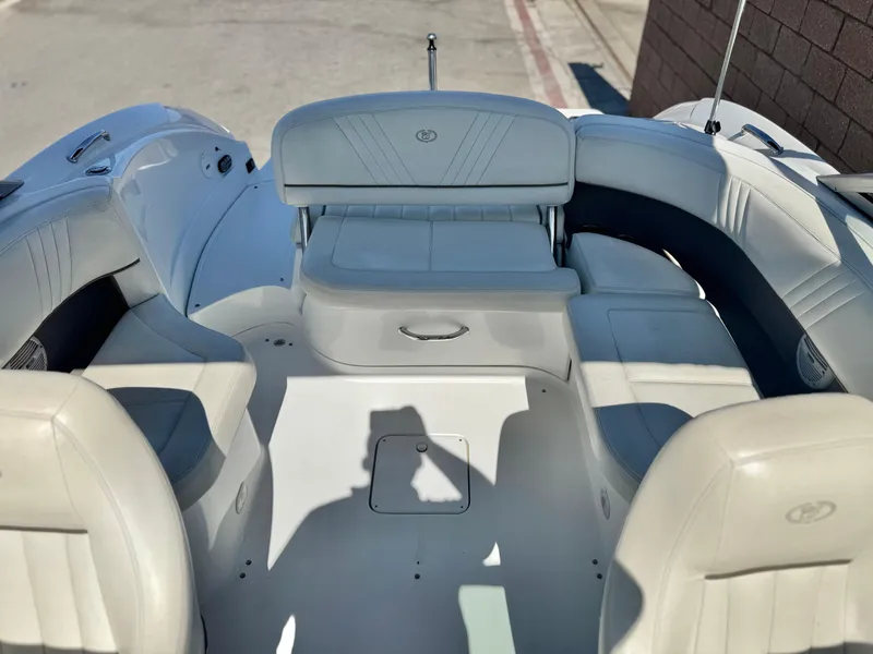 Slide: The Image of 2006 Cobalt 232 boat interior with white seating and shadow on deck. - 20