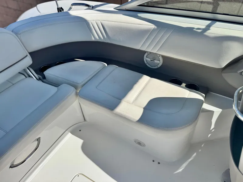 Slide: The Image of 2006 Cobalt 232 boat interior with white leather seating and speaker. - 22
