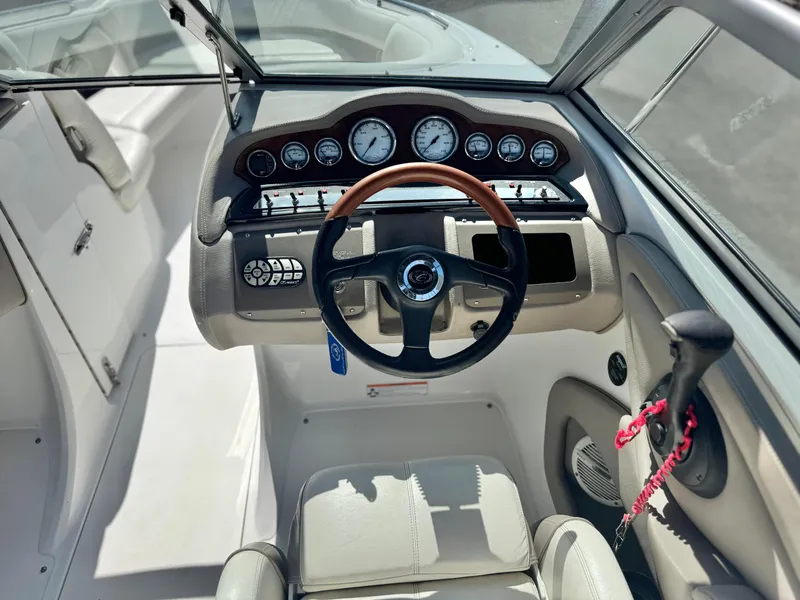 Slide: The Image of 2006 Cobalt 232 boat dashboard with steering wheel and instrument panel. - 30