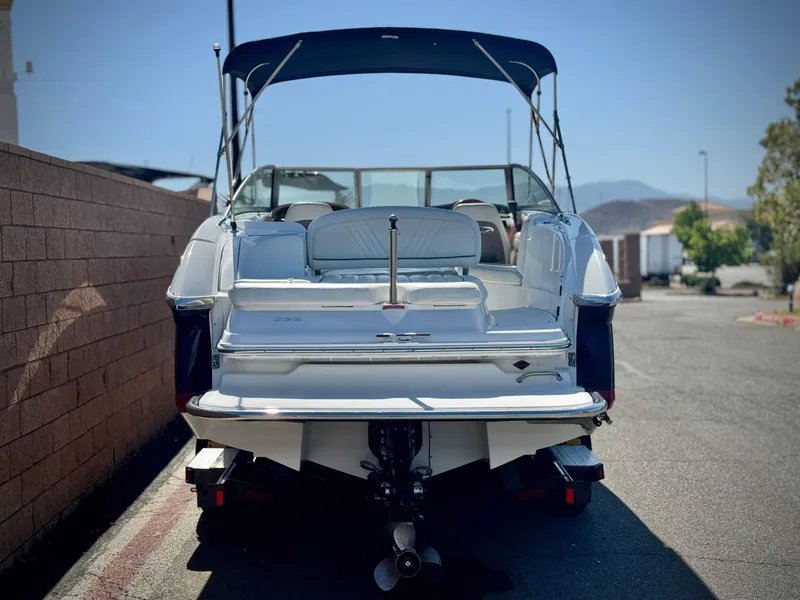 Slide: The Image of 2006 Cobalt 232 boat with canopy, parked on a sunny day. - 4