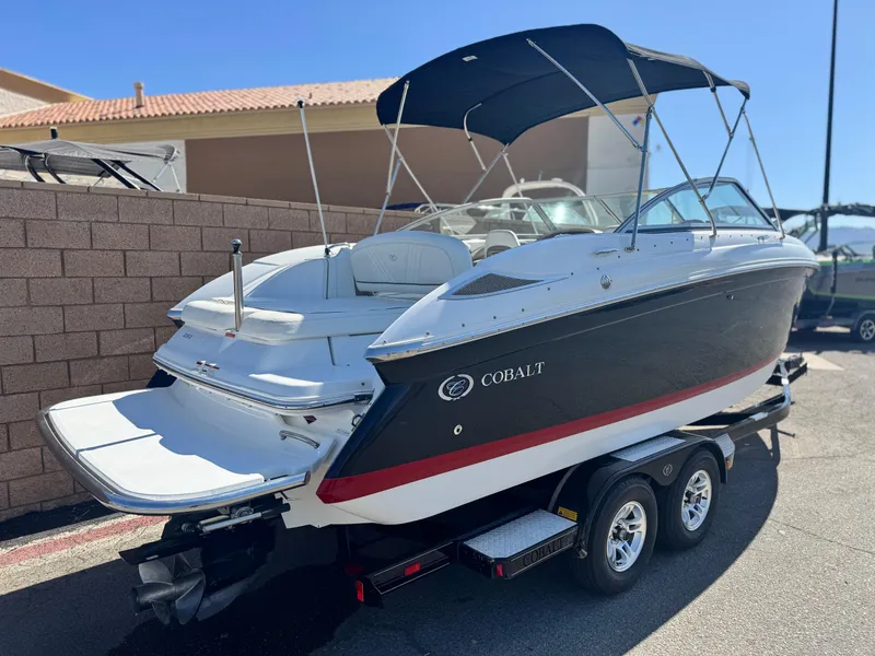 Slide: The Image of 2006 Cobalt 232 boat on trailer with canopy, parked outdoors. - 5