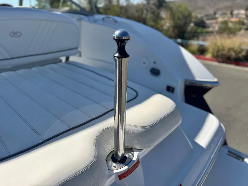 Slide: The Image of 2006 Cobalt 232 boat interior with white upholstery and stainless steel details. - 7