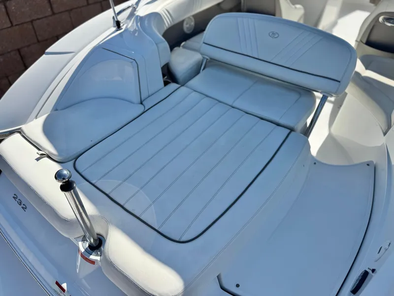 Slide: The Image of 2006 Cobalt 232 boat interior with white leather seating and sleek design. - 8