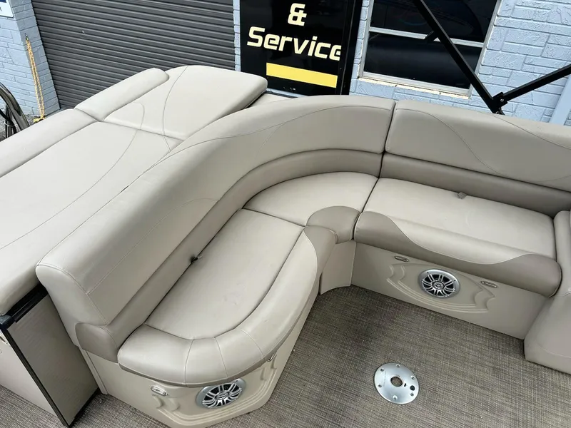 Slide: The Image of 2018 Avalon 2485 LSZ Cruise boat interior with beige seating and built-in speakers. - 10