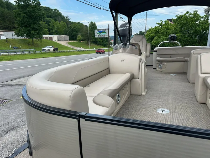 Slide: The Image of 2018 Avalon 2485 LSZ Cruise pontoon boat with beige seating, parked near a road. - 7