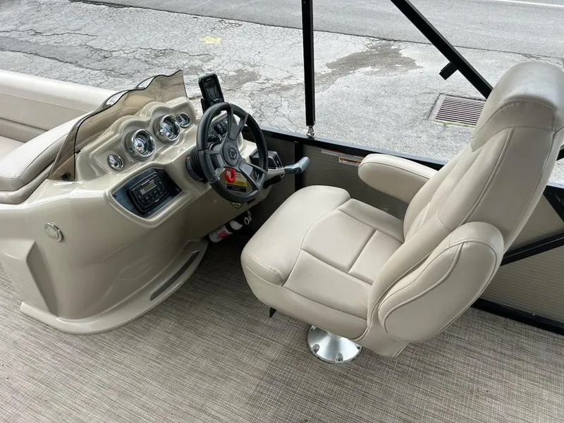 Slide: The Image of 2018 Avalon 2485 LSZ Cruise boat interior with beige captain's chair and control panel. - 9