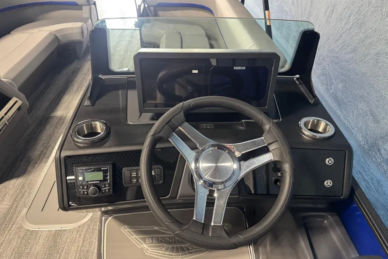 Slide: The Image of 2026 Bennington 24 MSB boat dashboard with steering wheel and navigation display. - 10