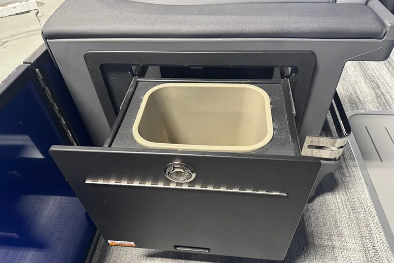 Slide: The Image of 2026 Bennington 24 MSB boat storage compartment with pull-out bin. - 12