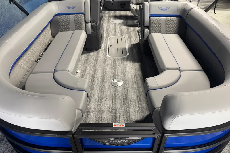 Slide: The Image of 2026 Bennington 24 MSB pontoon boat interior with gray seating and blue accents. - 4