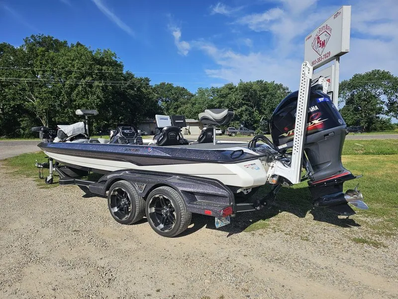 Slide: The Image of 2020 Skeeter FXR21 boat with Yamaha motor on a trailer, parked outdoors. - 3