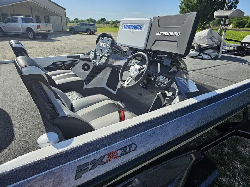 Slide: The Image of 2020 Skeeter FXR21 boat interior with advanced navigation systems, parked outdoors. - 9