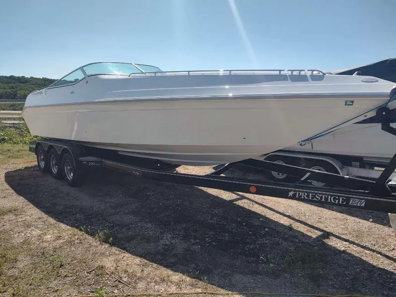 Slide: The Image of 1998 Envision 2900 Combo boat on a Prestige trailer, parked outdoors. - 1