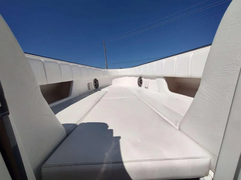 Slide: The Image of 1998 Envision 2900 Combo boat interior with white seating under clear blue sky. - 11