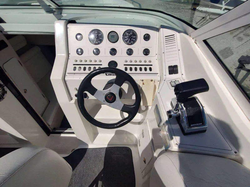 Slide: The Image of Cockpit of a 1998 Envision 2900 Combo boat with steering wheel and control panel. - 23