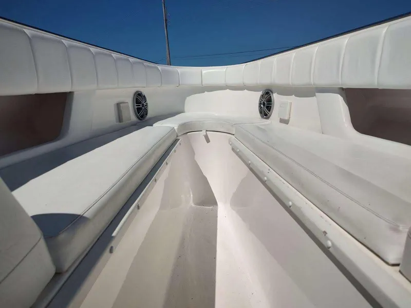 Slide: The Image of Interior view of a 1998 Envision 2900 Combo boat with white seating and speakers. - 24