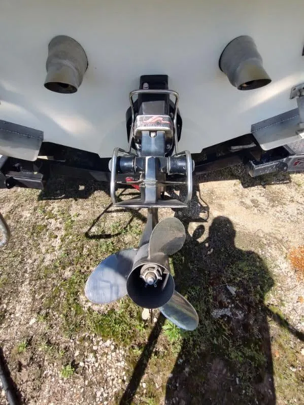 Slide: The Image of 1998 Envision 2900 Combo boat propeller and stern, on a grassy surface. - 30