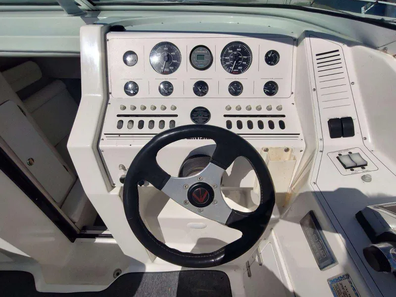 Slide: The Image of Control panel of a 1998 Envision 2900 Combo boat with steering wheel and gauges. - 35