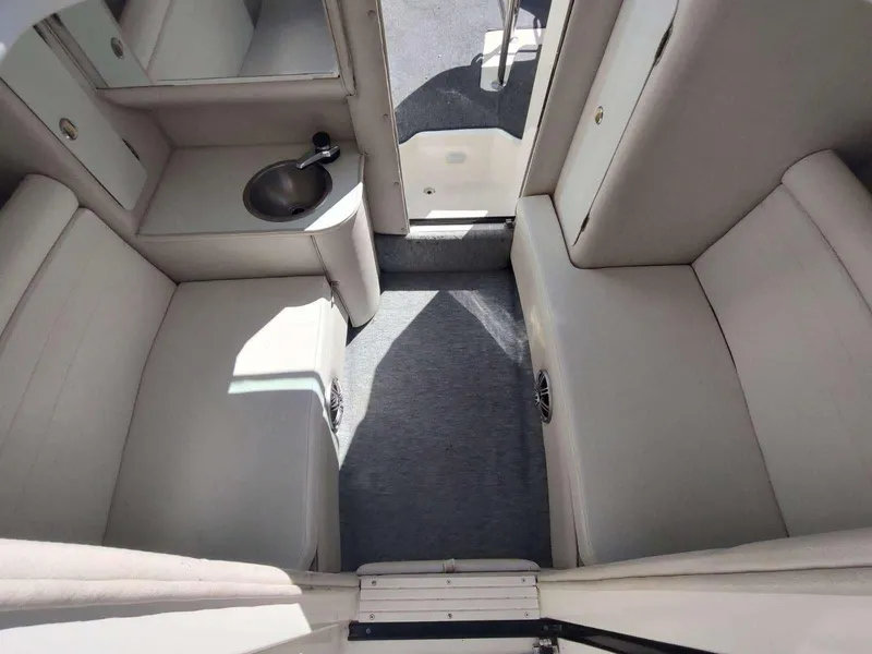 Slide: The Image of Interior of a 1998 Envision 2900 Combo boat with seating and a small sink. - 37