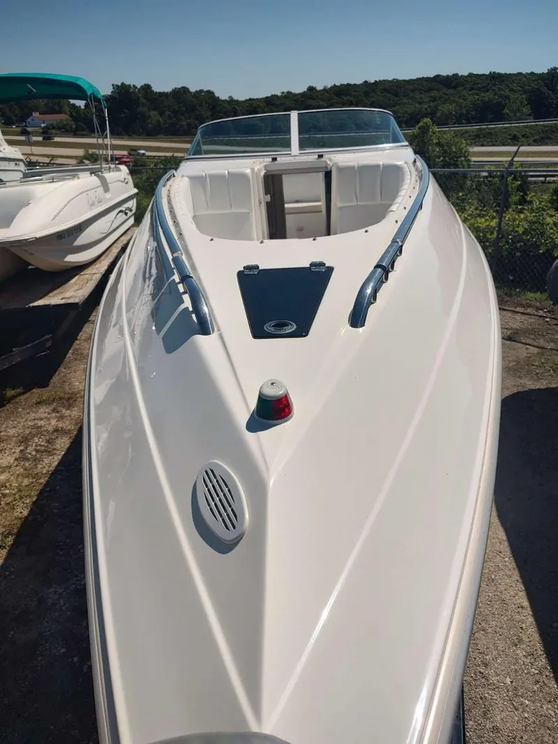 Slide: The Image of 1998 Envision 2900 Combo boat with sleek white design, docked outdoors. - 40