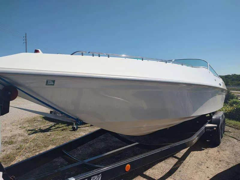 Slide: The Image of 1998 Envision 2900 Combo boat on trailer under clear blue sky. - 45