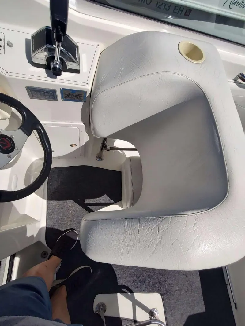 Slide: The Image of 1998 Envision 2900 Combo boat cockpit with white seating and steering wheel. - 46