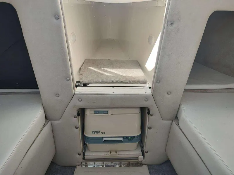 Slide: The Image of Interior of 1998 Envision 2900 Combo boat with compact toilet and seating area. - 5