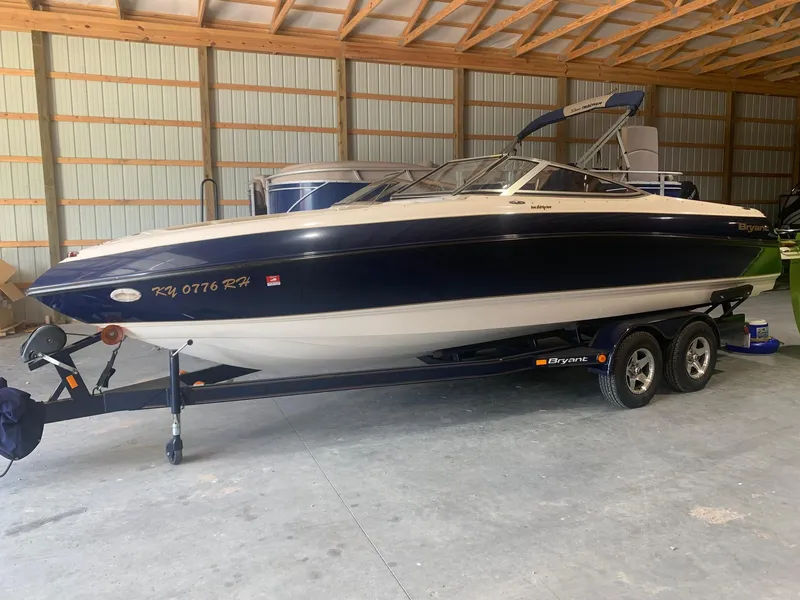 Slide: The Image of 2003 Bryant 232 RB boat on trailer in a storage facility. - 0