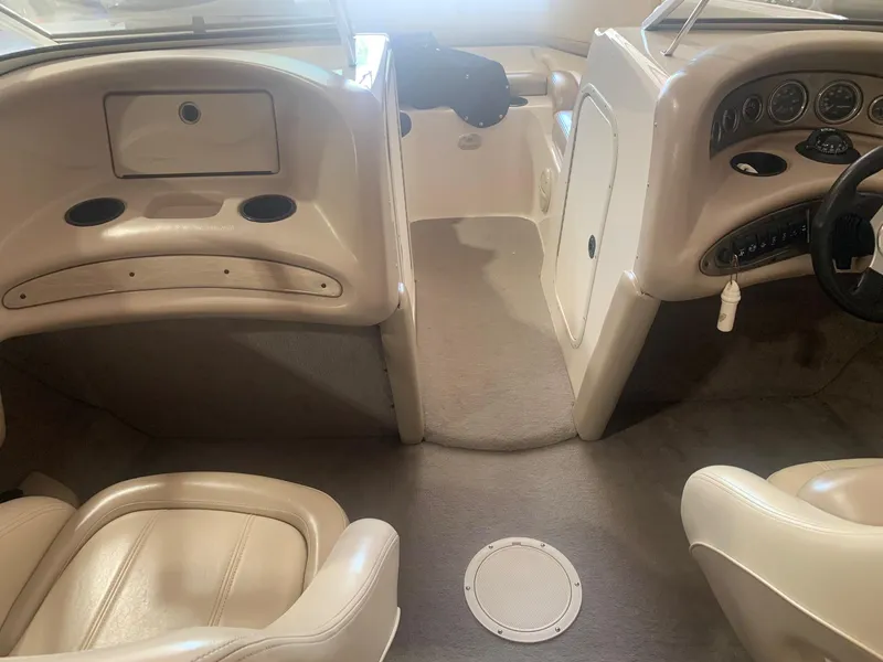 Slide: The Image of 2003 Bryant 232 RB boat interior with beige seating and dashboard. - 11