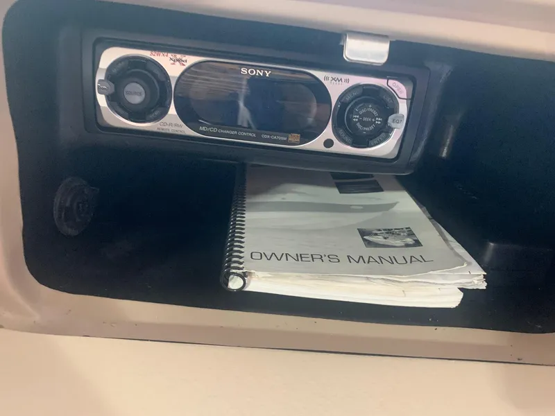 Slide: The Image of Sony stereo and owner's manual in a 2003 Bryant 232 RB boat compartment. - 13