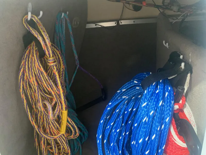 Slide: The Image of Colorful ropes stored in a 2003 Bryant 232 RB boat compartment. - 19