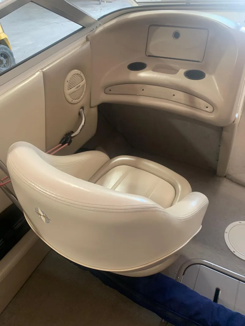 Slide: The Image of 2003 Bryant 232 RB boat interior with beige seating and cup holders. - 5