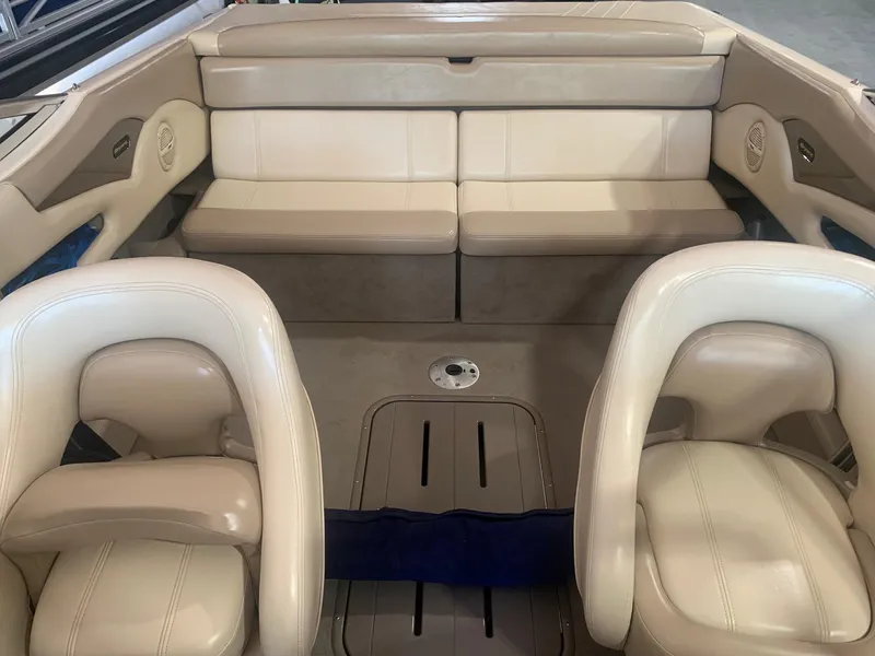 Slide: The Image of 2003 Bryant 232 RB boat interior with beige seating and spacious layout. - 7