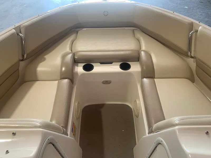 Slide: The Image of 2003 Bryant 232 RB boat interior with beige seating and cup holders. - 8