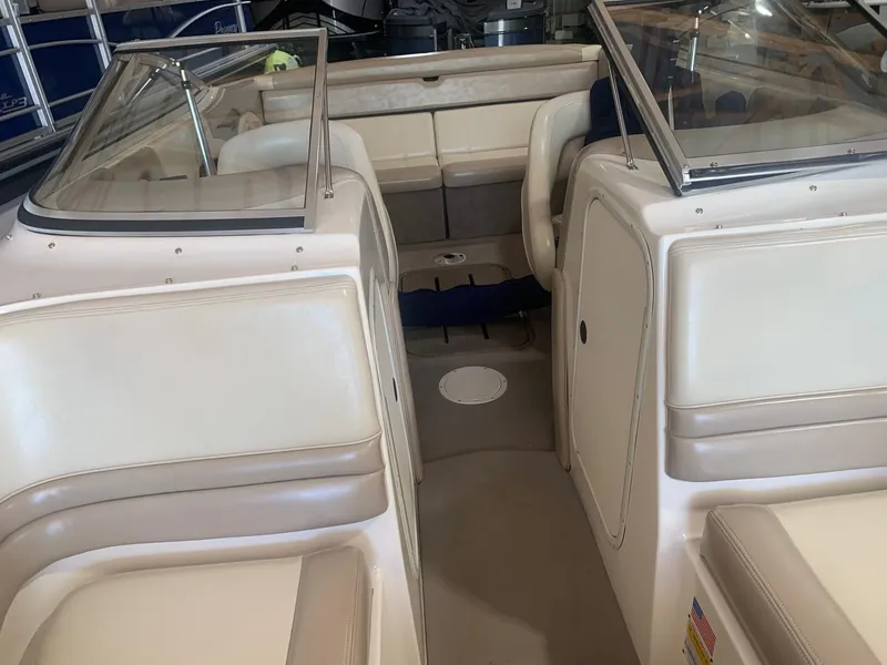 Slide: The Image of 2003 Bryant 232 RB boat interior with beige seating and windshield. - 9