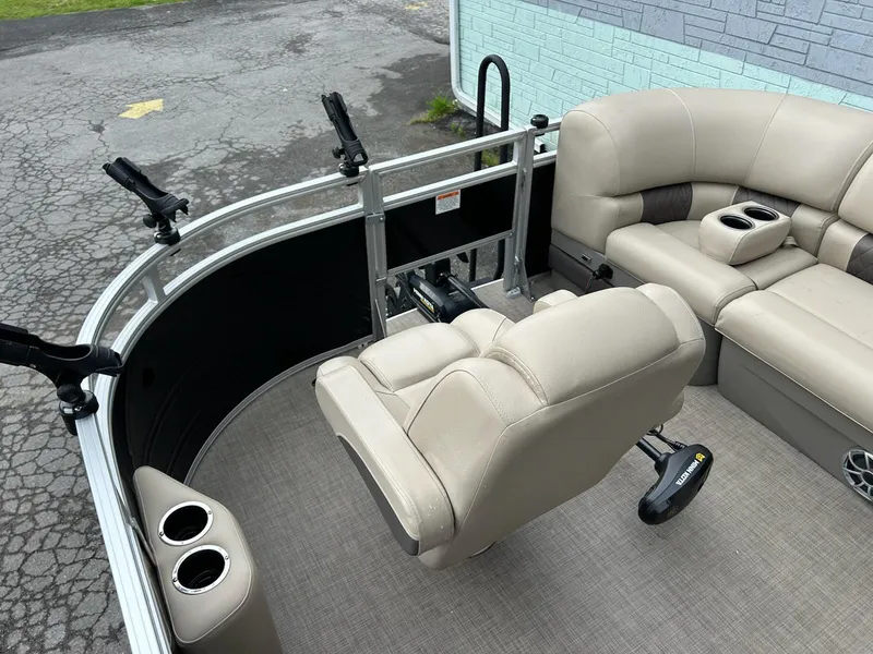 Slide: The Image of 2024 Sun Tracker Sport Fish 20 DLX pontoon boat interior with beige seating and cup holders. - 6