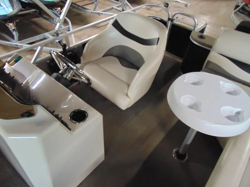Slide: The Image of 2012 Apex Marine 1716 boat interior with seating and cup holder table. - 10