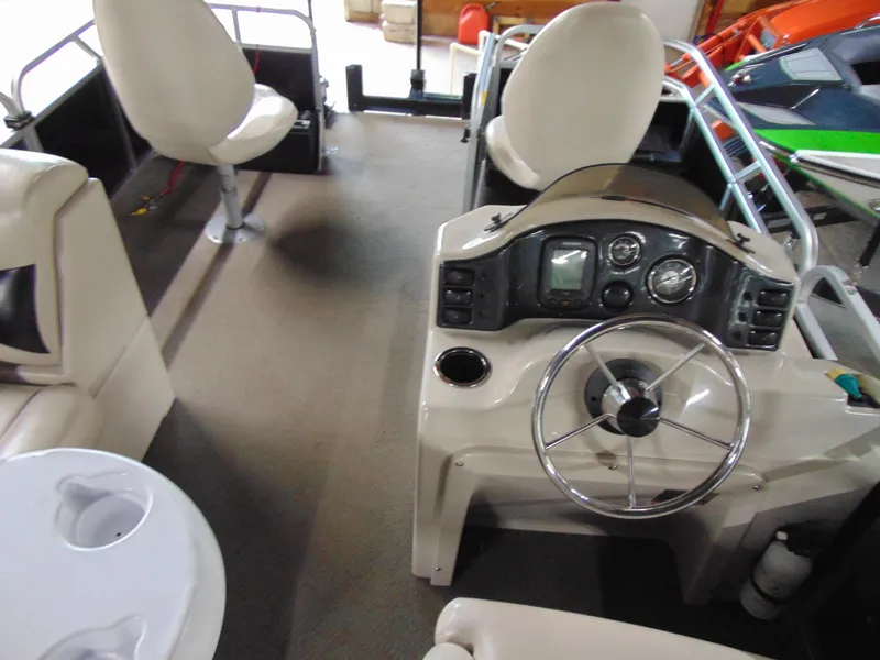 Slide: The Image of Interior of a 2012 Apex Marine 1716 boat with steering wheel and seating. - 12