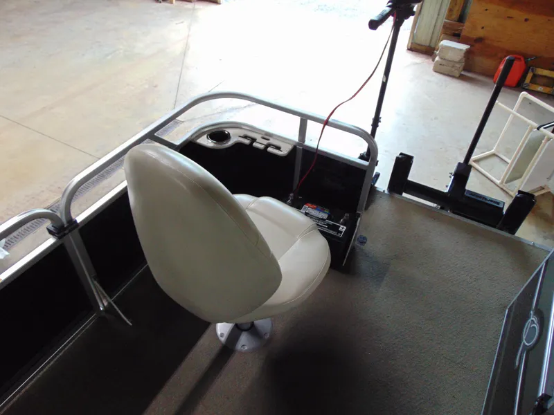 Slide: The Image of Interior of 2012 Apex Marine 1716 boat with white seat and control panel. - 14